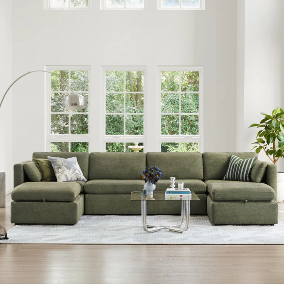 Olive green six-piece modular sofa set with wide chenille-upholstered seats, two storage ottomans with gas-lift lids, and plush reversible cushions — ideal for modern and mid-century inspired interiors.