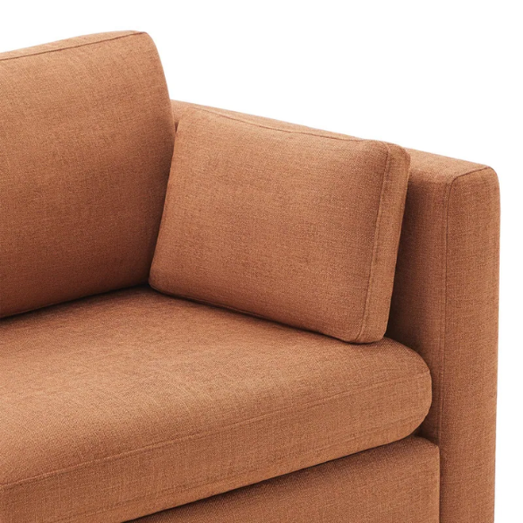 Terracotta five-piece modular sectional sofa with wide chenille seats, two gas-lift storage ottomans, and reversible cushions — designed for comfort and flexibility in modern homes.