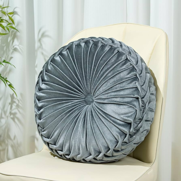 Gray velvet round throw pillow with ribbed edges and button closure, luxurious soft cotton fill, elegant decorative cushion for sofa or home décor.