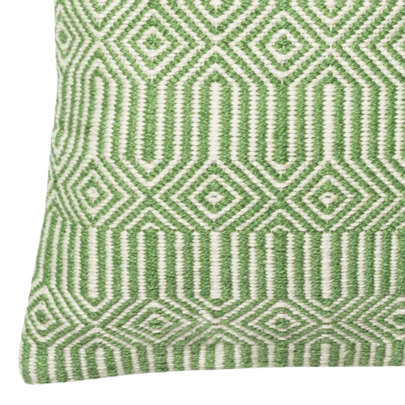Green and cream geometric throw pillow on outdoor seating with modern patio decor