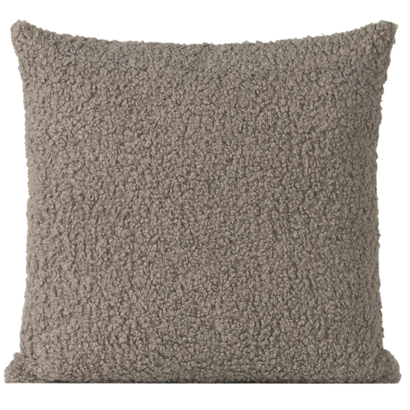 Grey bouclé throw pillow with soft looped texture, square accent pillow on a modern neutral-toned sofa