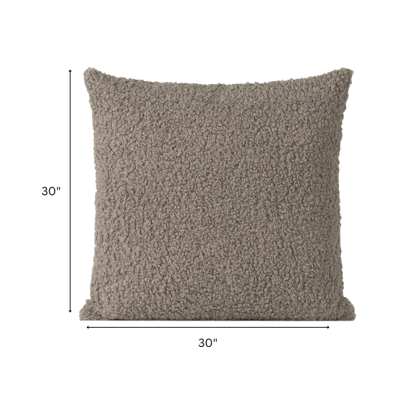 Grey bouclé throw pillow with soft looped texture, square accent pillow on a modern neutral-toned sofa