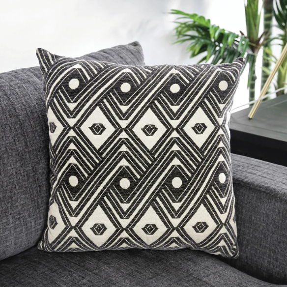 Modern grey chenille sectional sofa with chaise lounge, geometric accent pillows, and track arms in a contemporary living room setting