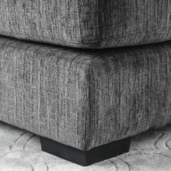 Modern grey chenille sectional sofa with chaise lounge, geometric accent pillows, and track arms in a contemporary living room setting.