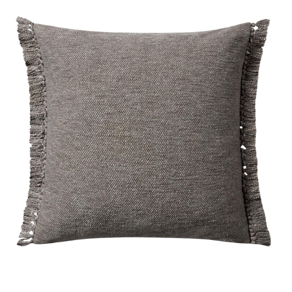 Grey cotton blend throw pillow with fringe, 22x22 square cushion featuring soft texture and hidden zipper, styled on a modern sofa for cozy, neutral decor.