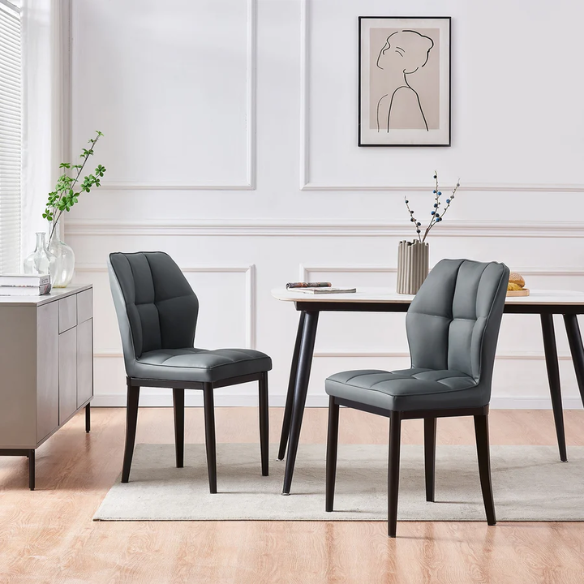 Grey faux leather dining chairs with checkered backrest and metal legs in a set of two