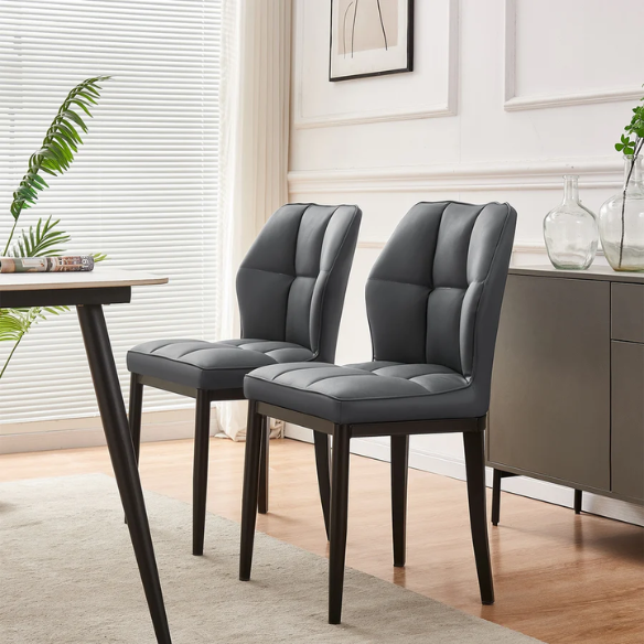 Grey faux leather dining chairs with checkered backrest and metal legs in a set of two