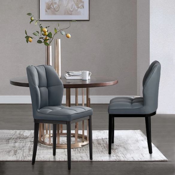 Grey faux leather dining chairs with checkered backrest and metal legs in a set of two