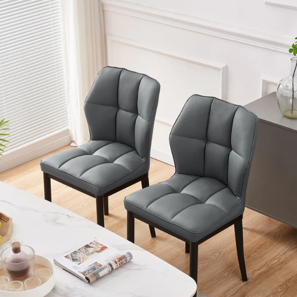 Grey faux leather dining chairs with checkered backrest and metal legs in a set of two