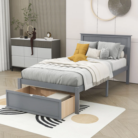 Grey twin platform bed made from solid pine wood with a rectangular headboard and a pull-out underbed storage drawer, featuring sturdy center support legs and a clean modern finish.
