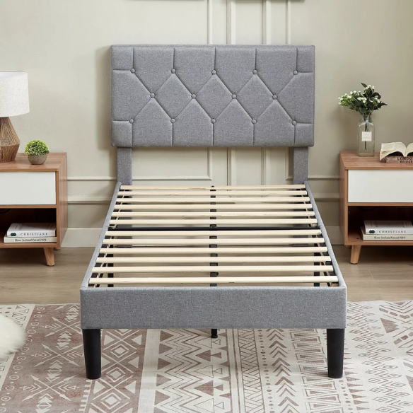 Modern grey upholstered twin bed with button-tufted headboard, steel frame, and slatted base – no box spring required