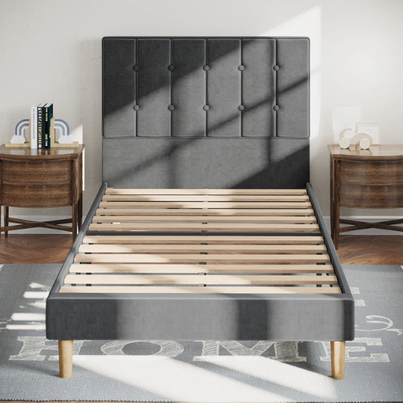 Grey twin bed frame with tufted velvet headboard, sturdy metal and wood construction, and 7.9-inch under-bed storage clearance.