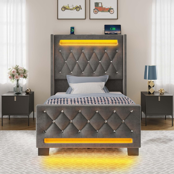 Modern grey twin bed with LED lights, USB charging ports, and upholstered velvet headboard and footboard – no box spring required