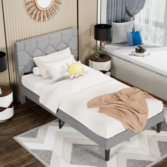 Grey upholstered twin platform bed frame with diamond-tufted linen headboard, sturdy metal construction, and center support legs, no box spring needed.