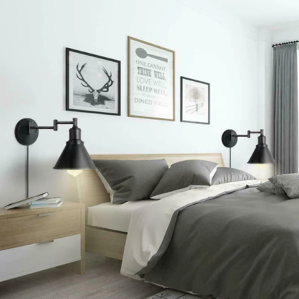 Industrial matte black swing arm wall sconce with adjustable arm and E26 bulb socket, perfect for vintage-inspired interiors.