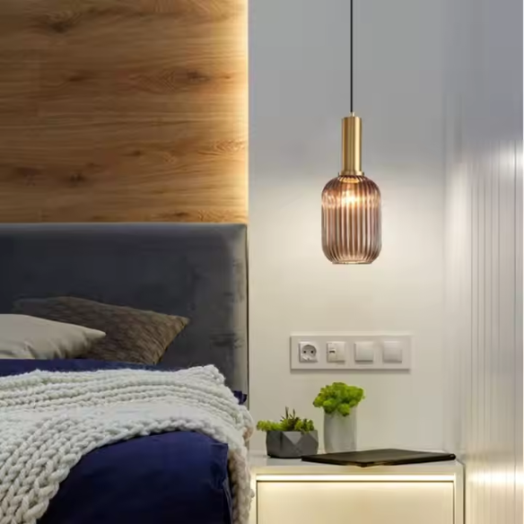Industrial vintage pendant light with ribbed amber glass and brass finish for modern home decor.