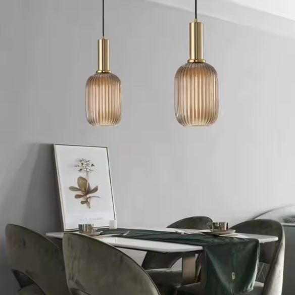 Industrial vintage pendant light with ribbed amber glass and brass finish for modern home decor.