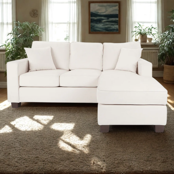 Ivory upholstered sectional sofa with reversible chaise, square arms, cushion back, and coffee-finished wood block legs