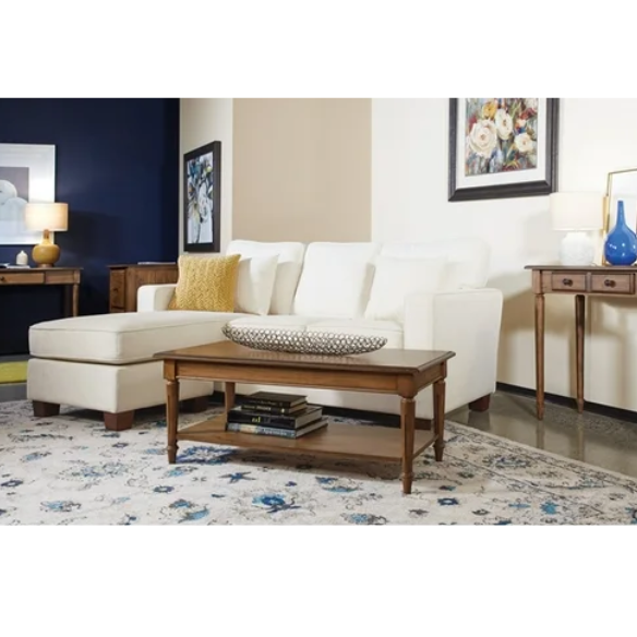 Ivory upholstered sectional sofa with reversible chaise, square arms, cushion back, and coffee-finished wood block legs