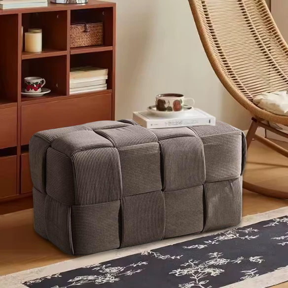 Light chocolate brown velvet ottoman with modern design and resilient sponge filling, perfect for living room or bedroom.