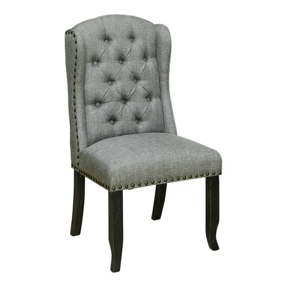 Set of two light grey farmhouse-style wingback dining chairs with button tufting, nailhead trim, and antique black tapered legs