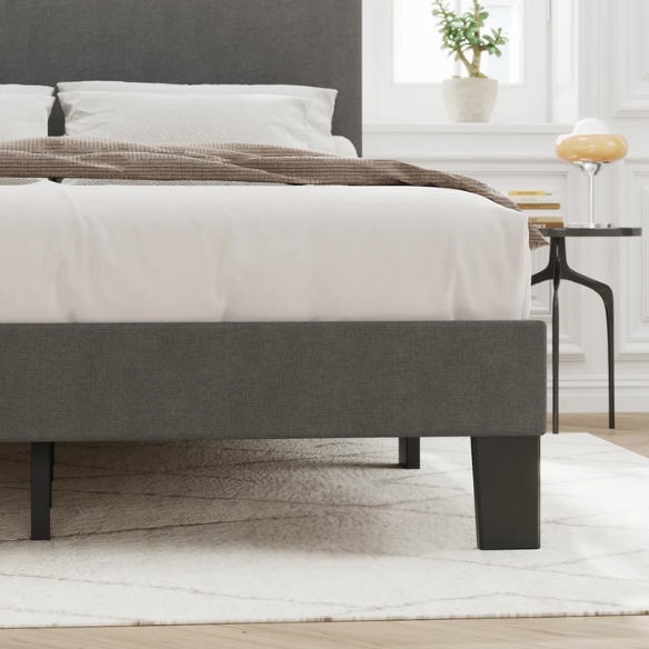 Light grey upholstered king-size platform bed with adjustable headboard, foam padding, and underbed storage clearance for modern bedrooms