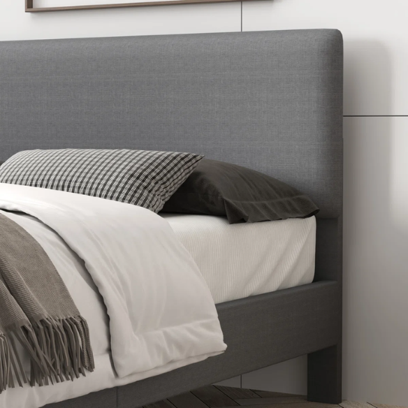 Light grey upholstered king-size platform bed with adjustable headboard, foam padding, and underbed storage clearance for modern bedrooms