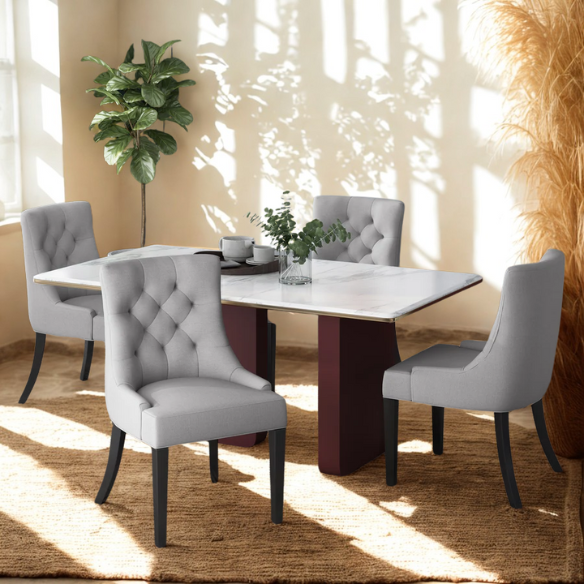 Set of four light grey upholstered dining chairs with diamond tufted backs, armless design, sloped armrests, and espresso brown wood legs.