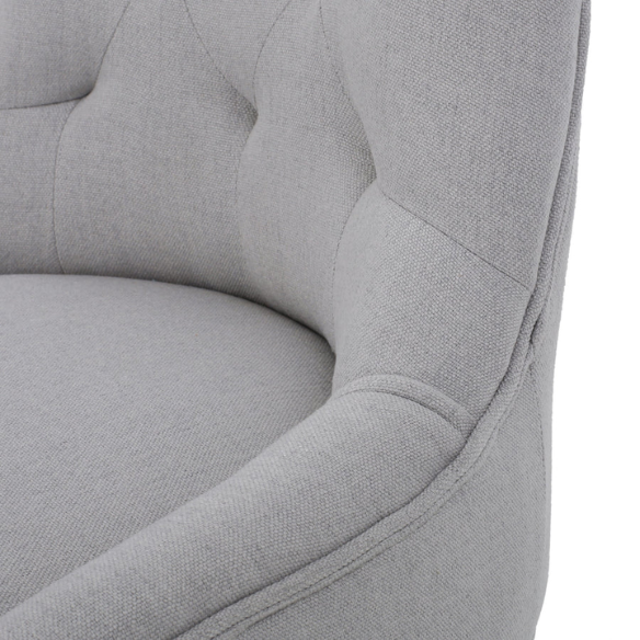 Set of four light grey upholstered dining chairs with diamond tufted backs, armless design, sloped armrests, and espresso brown wood legs.
