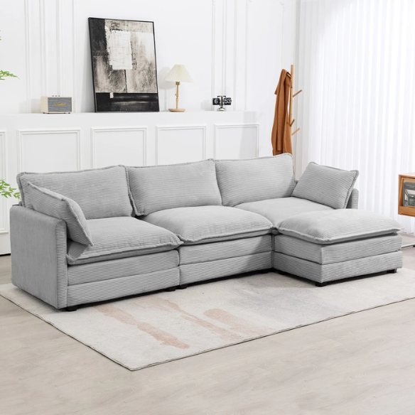 Light grey modular three-seater corduroy sectional sofa with movable ottoman, modern L-shaped couch for living room with soft cushions and sturdy wood-metal frame.