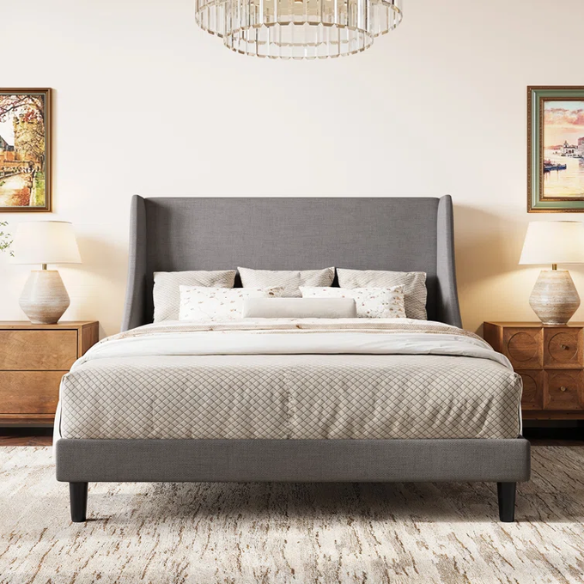 Light grey linen upholstered queen platform bed with wingback headboard, tapered black legs, and slatted support – no box spring needed