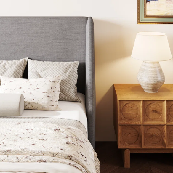 Light grey linen upholstered queen platform bed with wingback headboard, tapered black legs, and slatted support – no box spring needed