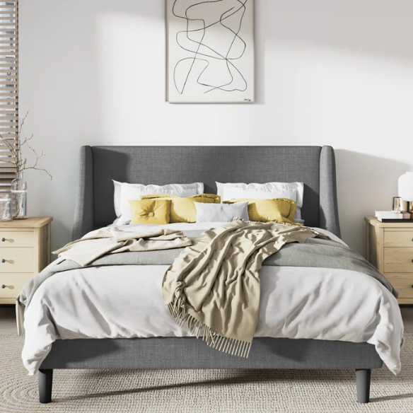 Light grey linen upholstered queen platform bed with wingback headboard, tapered black legs, and slatted support – no box spring needed