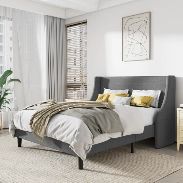 Light grey linen upholstered queen platform bed with wingback headboard, tapered black legs, and slatted support – no box spring needed