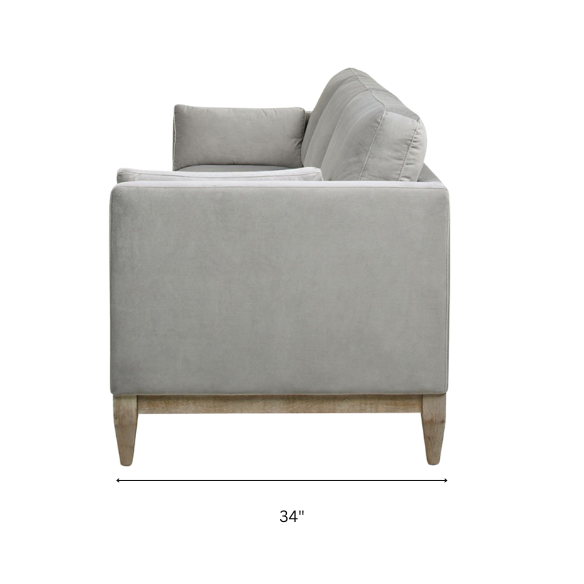 Light grey velvet 3-seater sofa with feather-down cushions, track arms, and natural wood legs, designed for modern and transitional spaces.