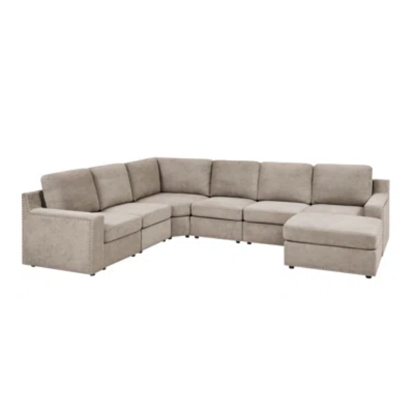 Spacious light taupe U-shaped sectional sofa with reversible configuration, removable cushions, nailhead trim, and matching ottoman—seats up to 8.