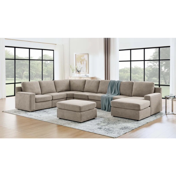 Spacious light taupe U-shaped sectional sofa with reversible configuration, removable cushions, nailhead trim, and matching ottoman—seats up to 8.