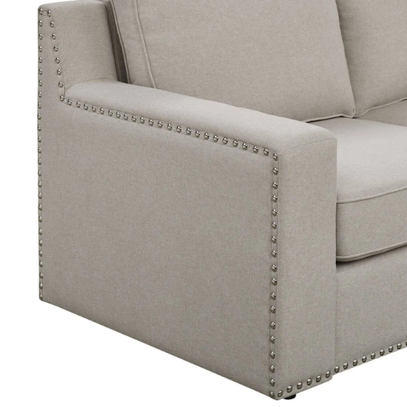 Spacious light taupe U-shaped sectional sofa with reversible configuration, removable cushions, nailhead trim, and matching ottoman—seats up to 8.
