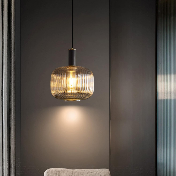 Modern amber glass pendant light with gold finish, perfect for contemporary interiors.