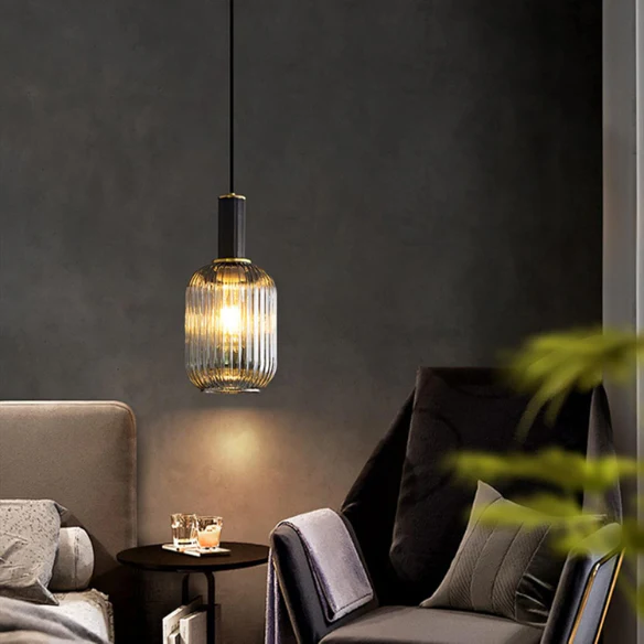 Modern black glass pendant light with frosted smoke gray shade and brass finish for contemporary home decor.