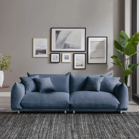 Modern blue upholstered sofa with deep seating and chrome-finished legs, featuring 4 matching accent pillows for a clean, contemporary living room look.