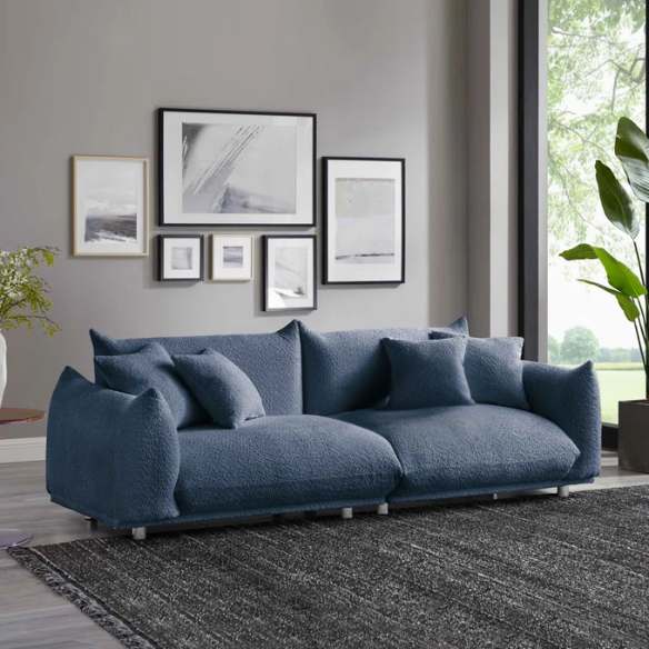 Modern blue upholstered sofa with deep seating and chrome-finished legs, featuring 4 matching accent pillows for a clean, contemporary living room look.