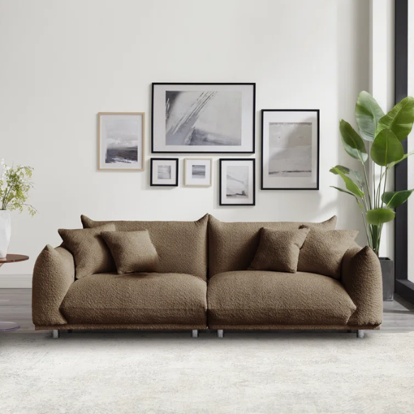 Modern camel upholstered sofa with deep seating and chrome-finished legs, featuring 4 matching accent pillows, ideal for stylish living rooms.