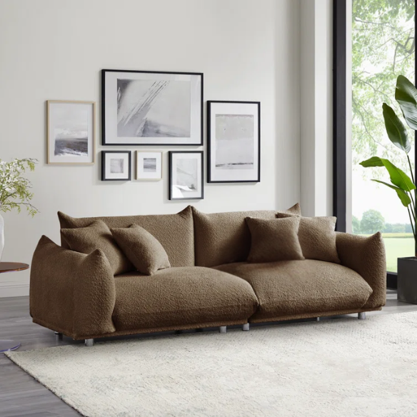 Modern camel upholstered sofa with deep seating and chrome-finished legs, featuring 4 matching accent pillows, ideal for stylish living rooms.