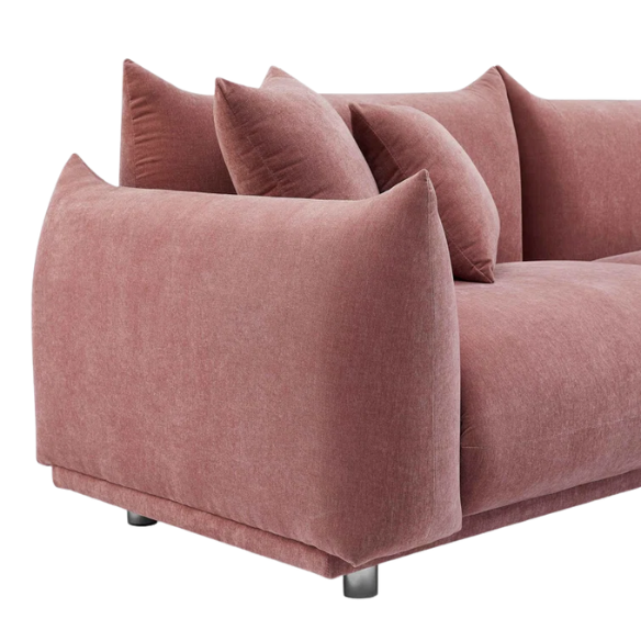 Modern dusty rose upholstered sofa with deep seating and chrome-finished legs, featuring four matching accent pillows—ideal for soft, stylish living spaces.