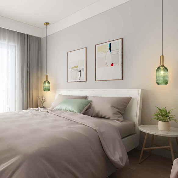 Modern green glass pendant light with gold finish, perfect for contemporary interiors.