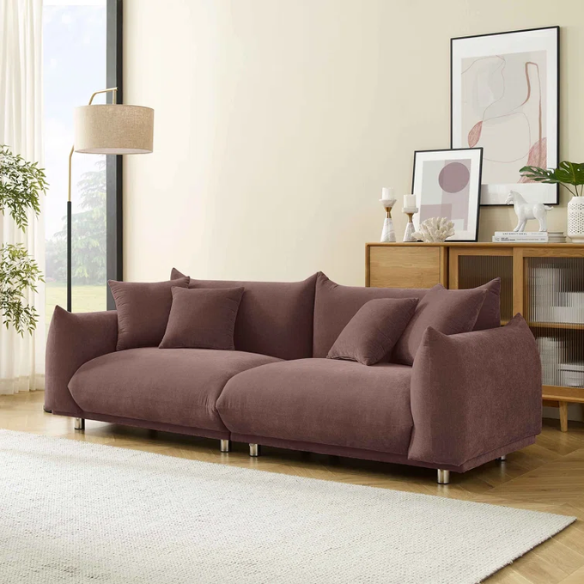 Modern muted brown upholstered sofa with deep seating and chrome-finished legs, featuring four matching accent pillows—ideal for warm, modern interiors.