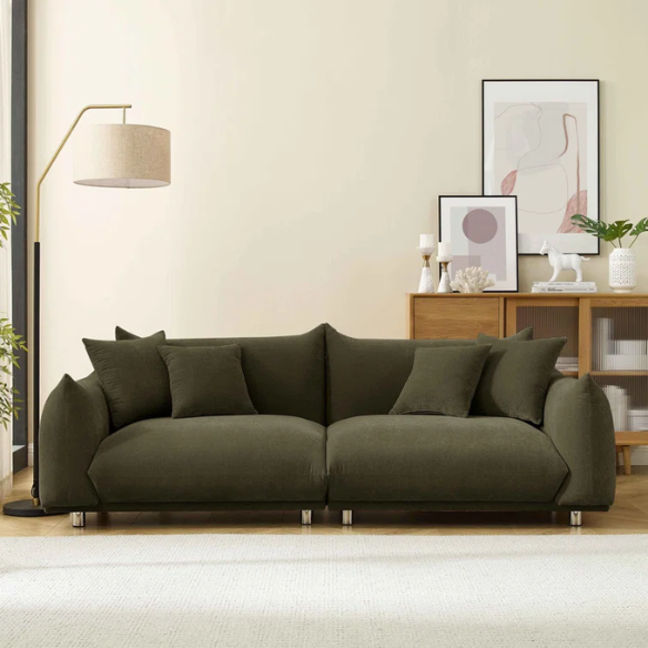 Modern olive drab upholstered sofa with deep seating and chrome-finished legs, featuring 4 matching accent pillows—perfect for modern and rustic interiors.