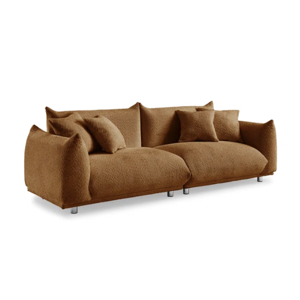Modern rust brown upholstered sofa with deep seating and chrome-finished legs, featuring 4 matching accent pillows for a warm, stylish living room.