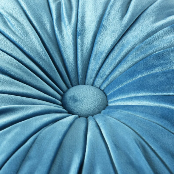 Muted blue velvet round throw pillows with pleated detailing and button center, 14.5-inch set of two styled on a neutral-toned sofa.